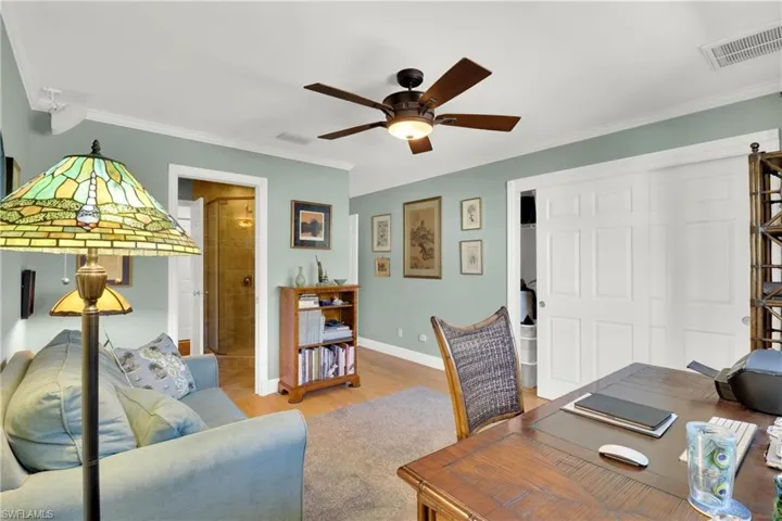 Home office featuring a ceiling fan and crown molding
