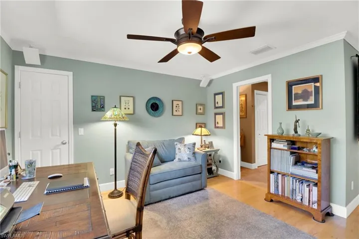 Office area with wood finished floors, crown molding, and ceiling fan