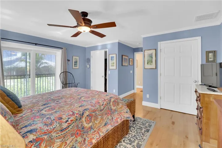Bedroom featuring access to exterior, light wood-style floors, ceiling fan, and ornamental molding