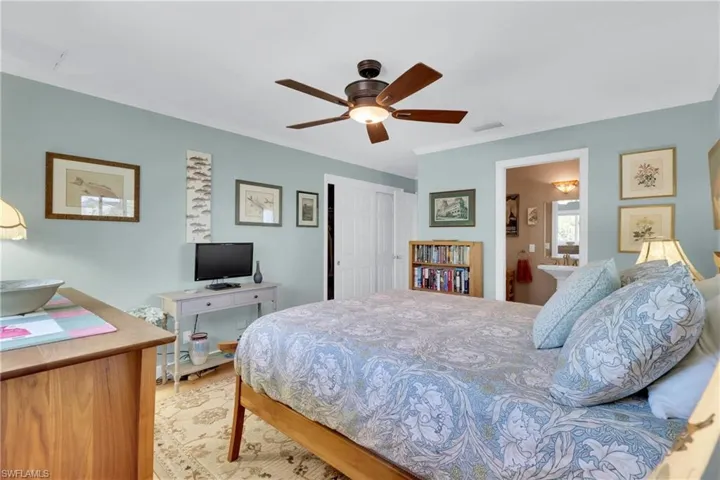 Bedroom featuring a closet, crown molding, ceiling fan, and connected bathroom