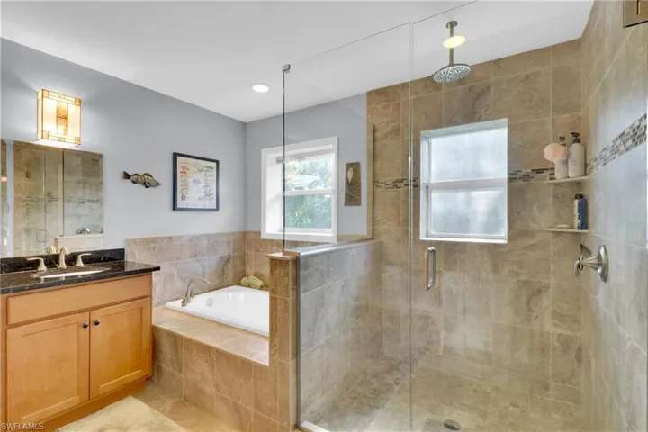 Full bath with vanity, a bath, a stall shower, light tile patterned flooring, and recessed lighting
