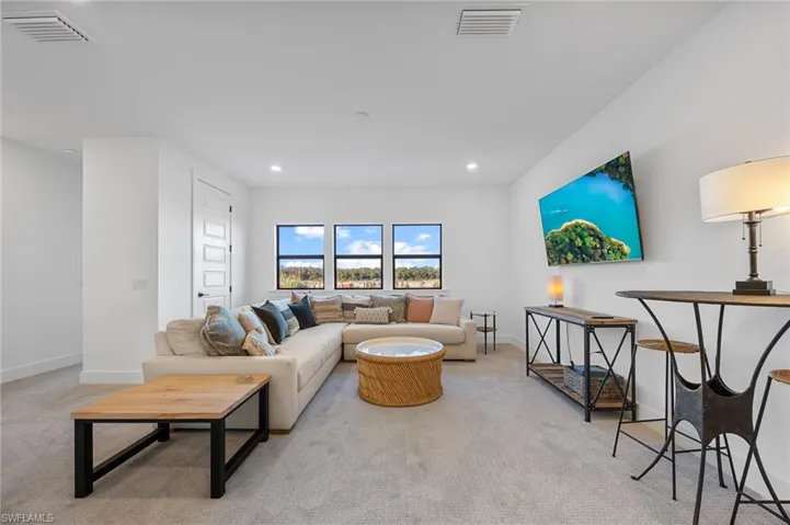 Living room featuring light carpet and recessed lighting