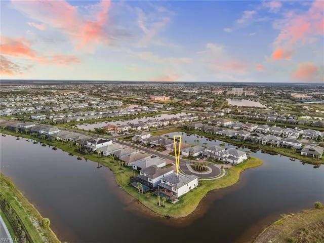 Aerial view of residential area featuring a nearby body of water