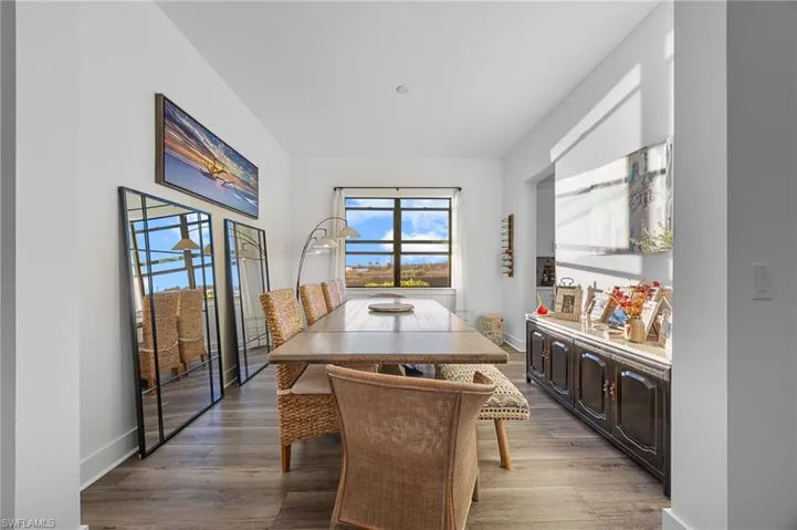 Dining space featuring dark wood-type flooring and baseboards