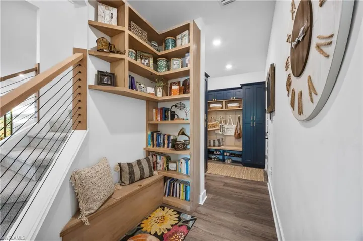 Hall featuring dark wood-type flooring and recessed lighting
