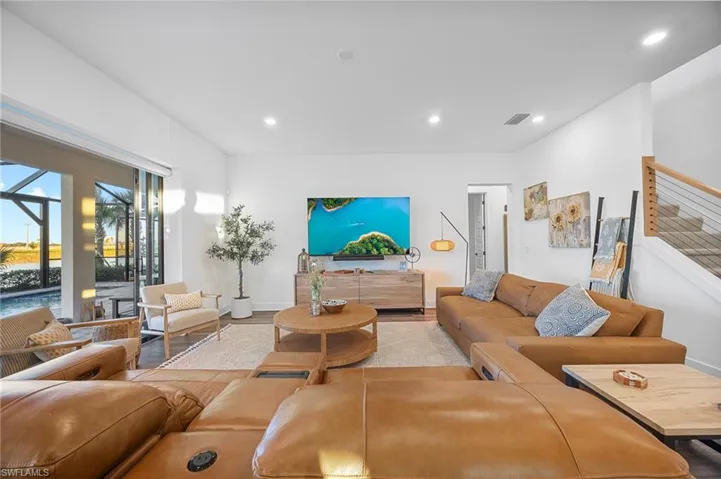 Living area featuring wood finished floors and recessed lighting