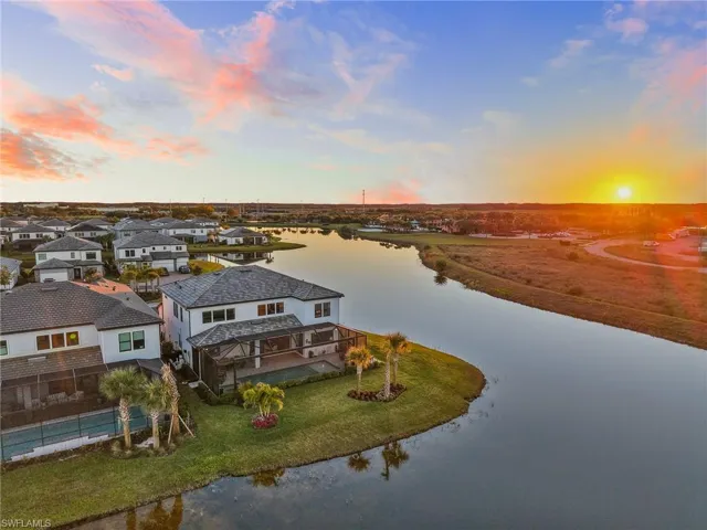 Aerial perspective of suburban area featuring a nearby body of water