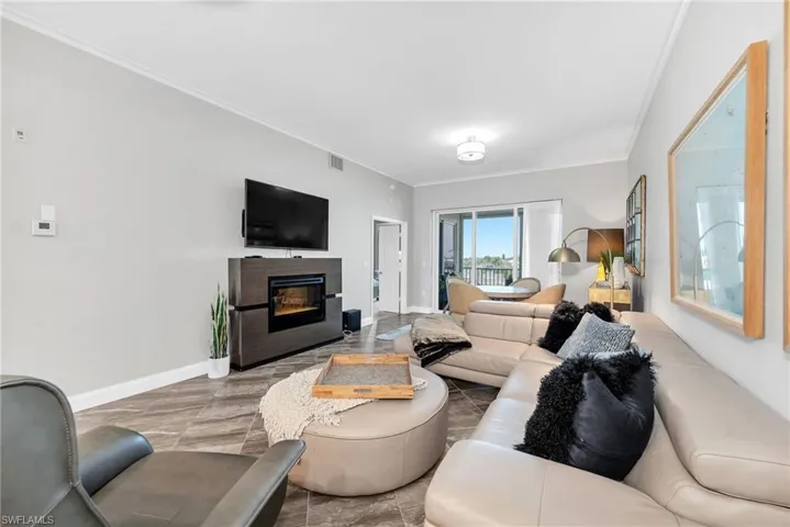 Open living area with wood-finish flooring and a built-in fireplace feature