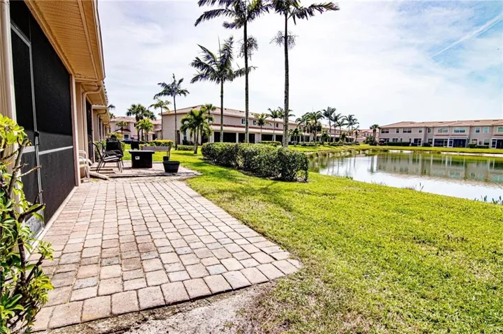 Paver seating area outside screened lanai viewing the lake