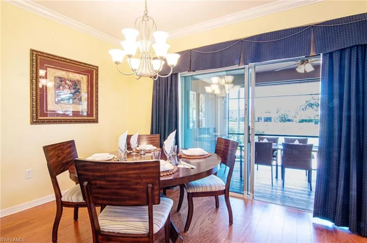 Formal dining with screen lanai under truss and lake water view