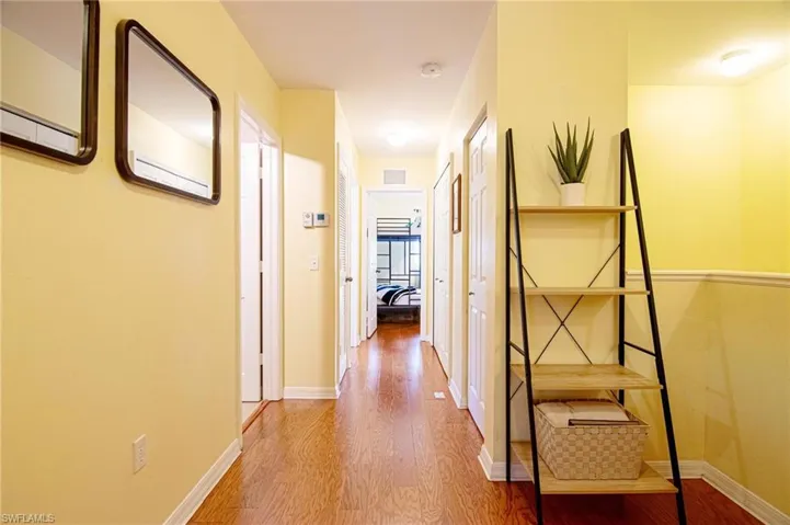 View from top of stairs hallway to second and third bedrooms and bath
