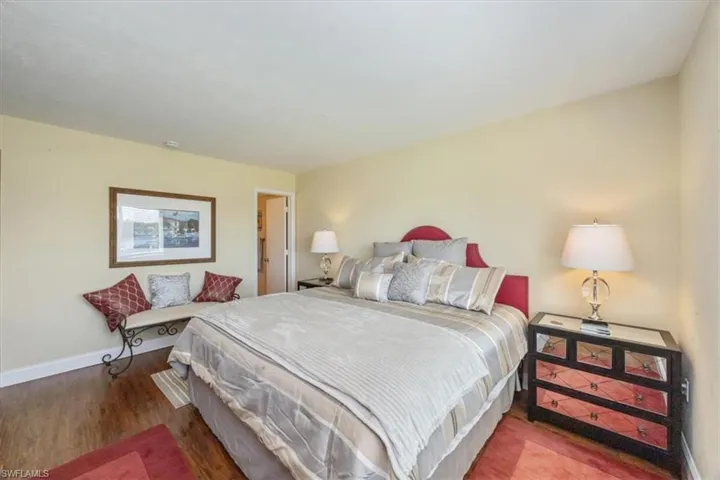 Bedroom with baseboards and wood finished floors