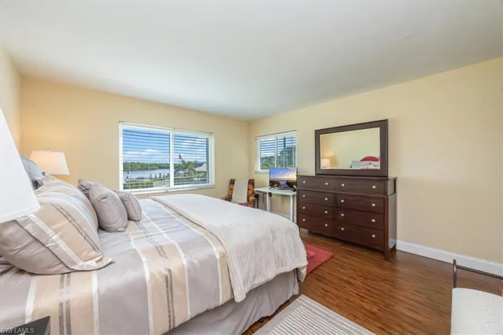Bedroom with wood finished floors and baseboards