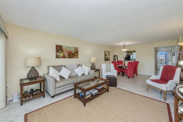Living room with light tile patterned floors and baseboards