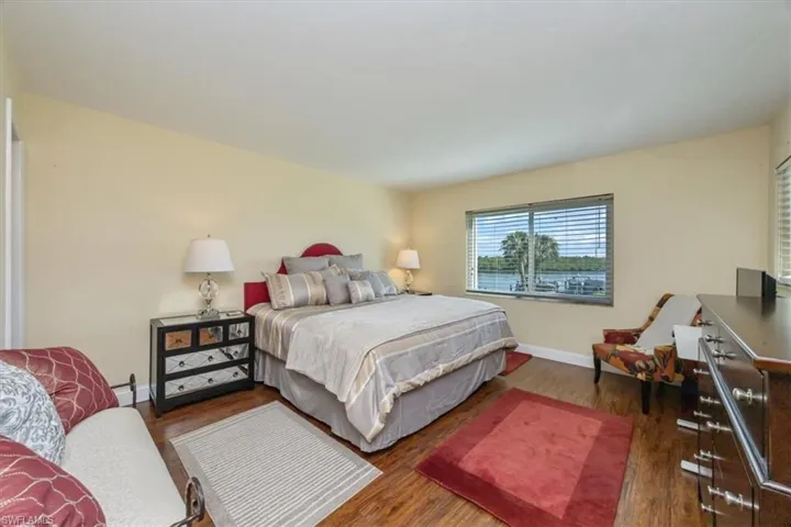 Bedroom featuring wood finished floors and baseboards