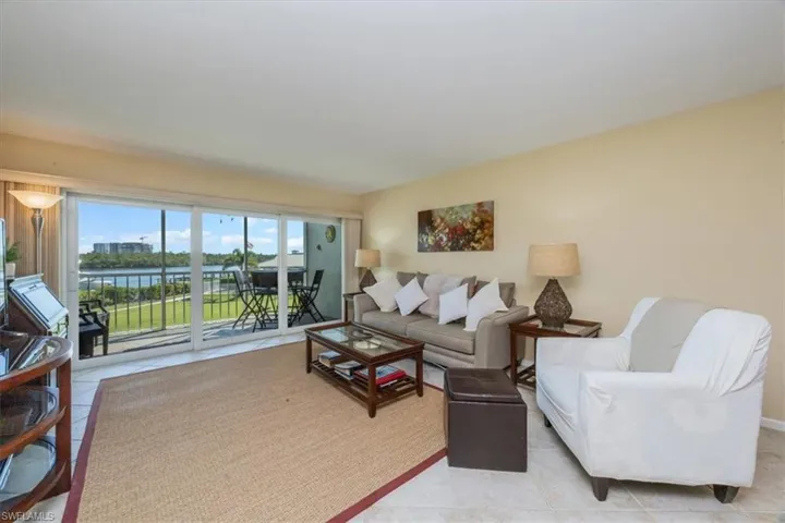 Living room with a water view and light tile patterned flooring