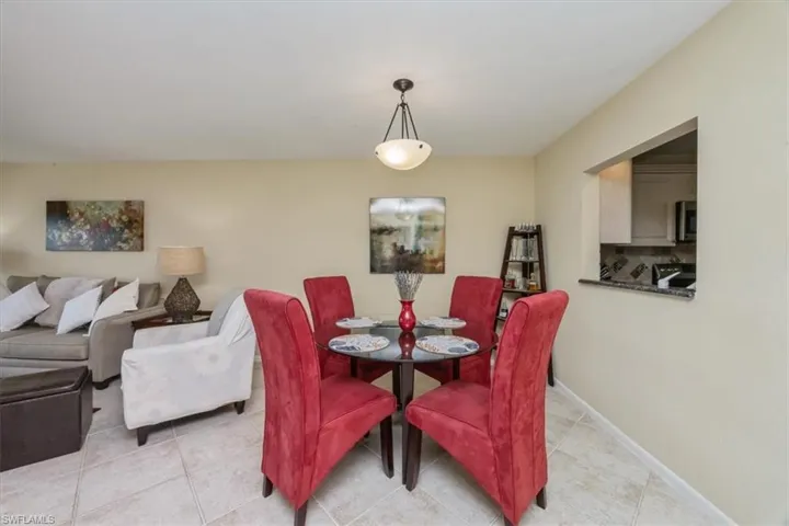 Dining space with light tile patterned floors