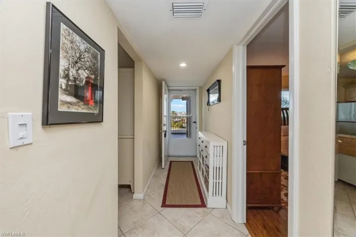 Corridor featuring light tile patterned flooring and recessed lighting