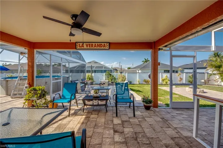 Sunroom with a residential view, ceiling fan, and healthy amount of natural light