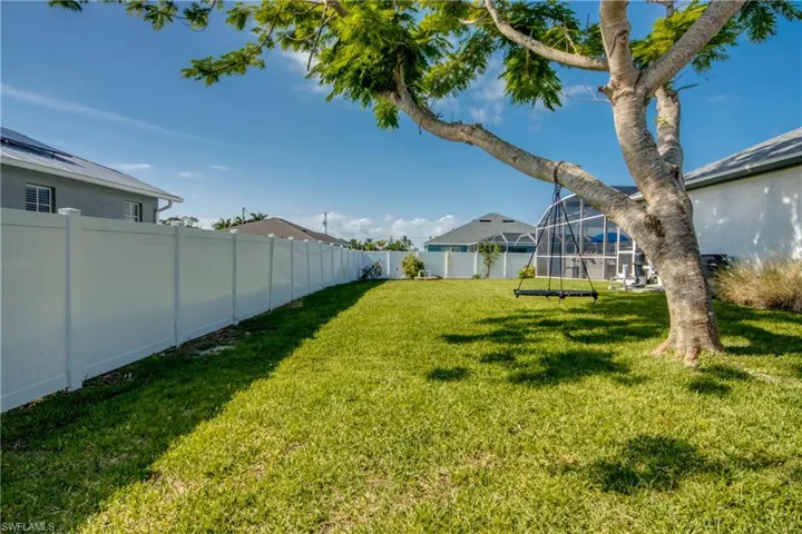 View of yard featuring glass enclosure
