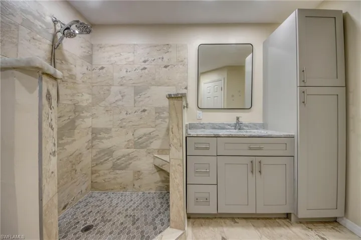 Bathroom with a tile shower and vanity