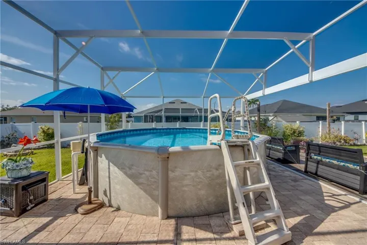 View of pool with a lanai and a patio