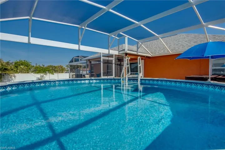 View of pool with a lanai and a patio area