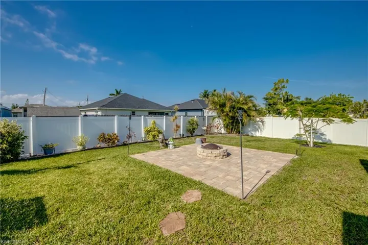 View of yard featuring a patio area and an outdoor fire pit