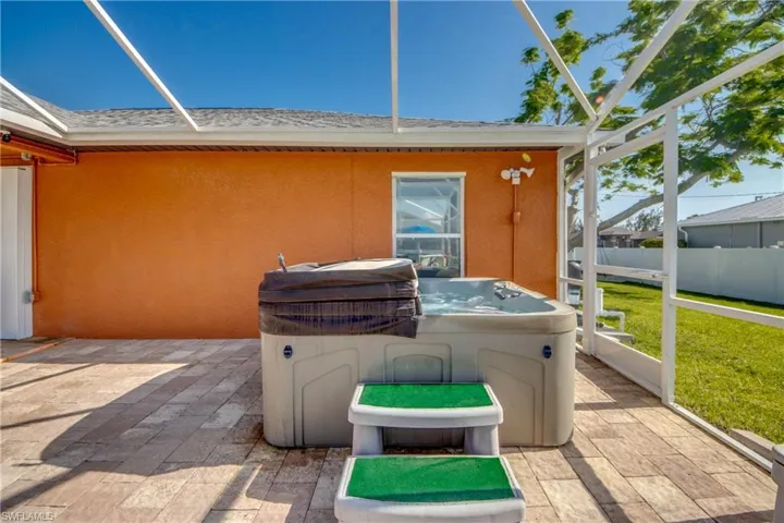 View of patio with a hot tub