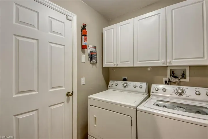 Laundry room with independent washer and dryer and cabinet space