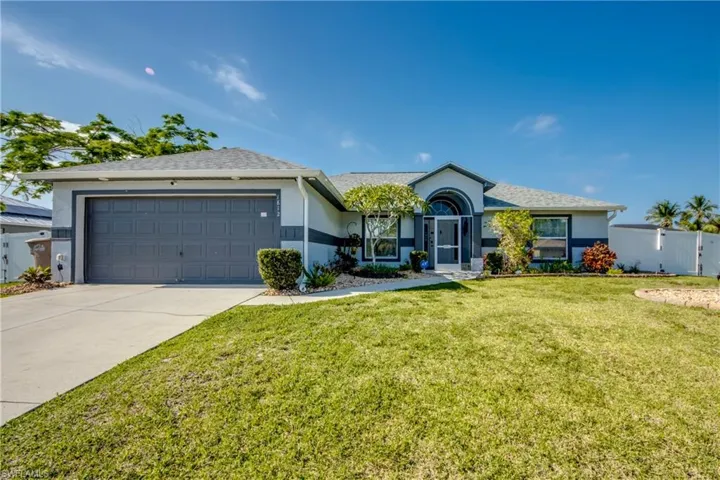Single story home with stucco siding, concrete driveway, and an attached garage