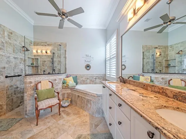 Primary  bedroom en-suite with dual sinks, walk in shower and soaking tub