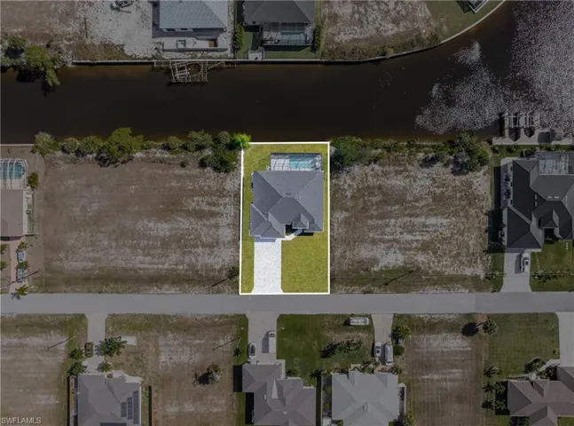 Aerial overview of property's location with a nearby body of water and nearby suburban area