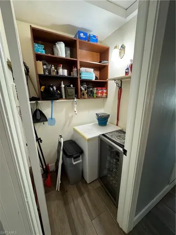 Small room with freezer and drink cooler.