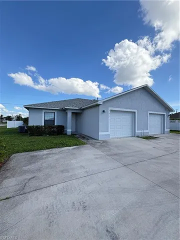 Ranch-style home with a garage, cooling unit, and a front lawn
