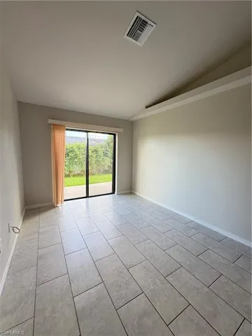 Tiled empty room with vaulted ceiling