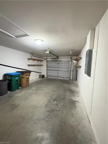 Garage with a garage door opener and electric panel