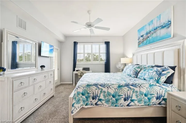 Bedroom featuring light carpet and ceiling fan