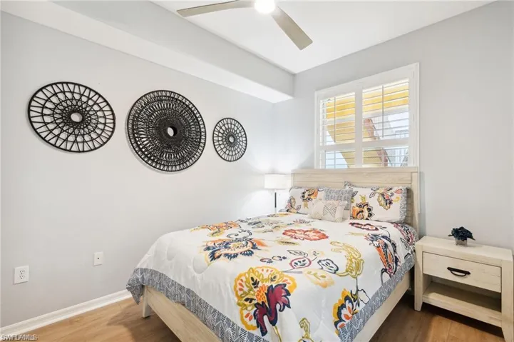 Bedroom with wood finished floors and a ceiling fan