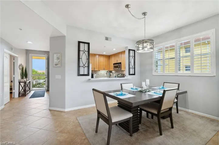 Dining space featuring light tile patterned floors and recessed lighting