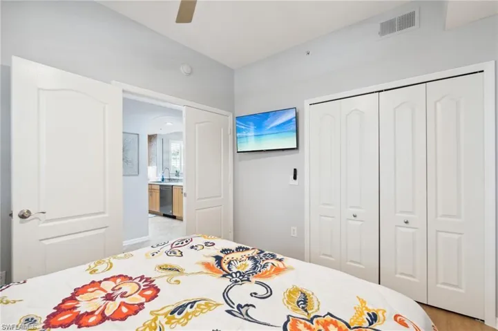 Bedroom with a closet, ceiling fan, and light wood-style floors
