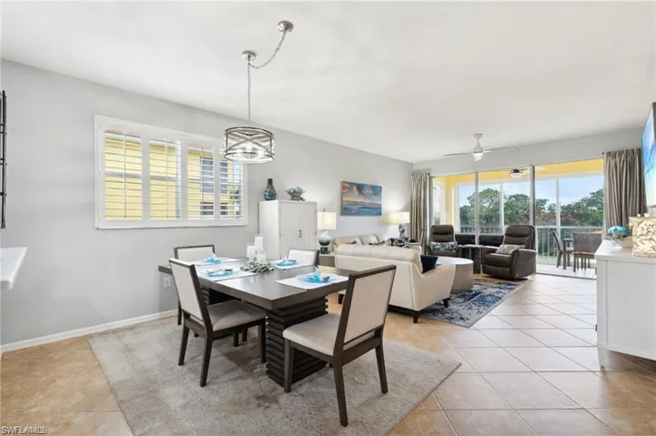 Dining room featuring plenty of natural light, light tile patterned flooring, and ceiling fan