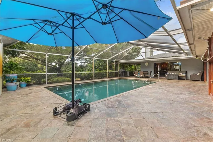 View of pool featuring a patio and a lanai