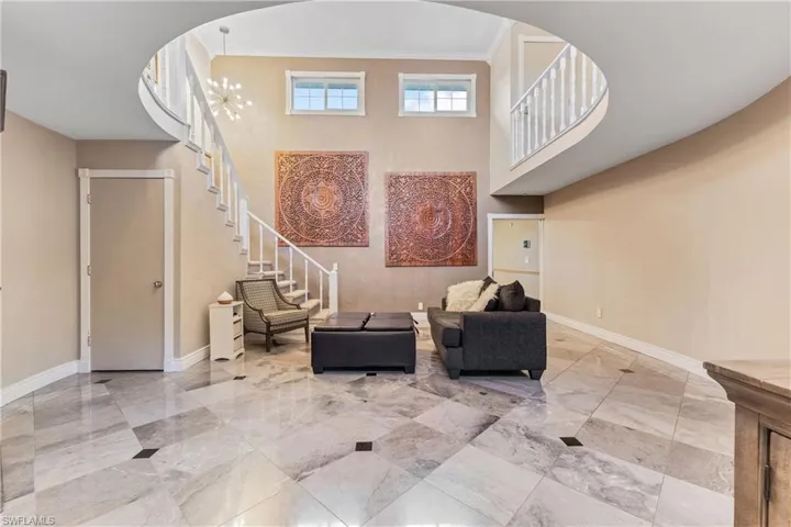 Sitting room featuring crown molding and an inviting chandelier