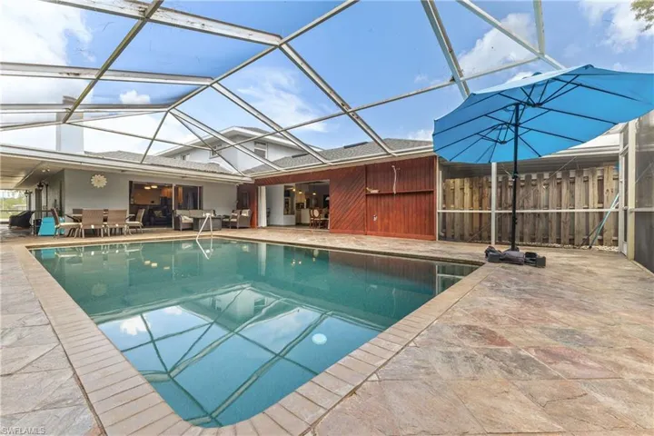 View of swimming pool with a lanai and a patio area