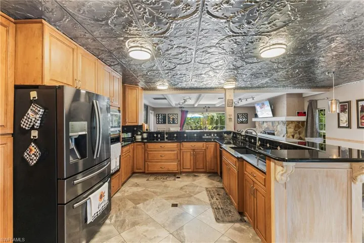 Kitchen featuring kitchen peninsula, sink, decorative light fixtures, and appliances with stainless steel finishes