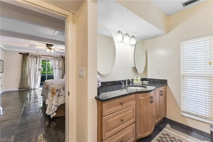 Bathroom with ceiling fan and vanity