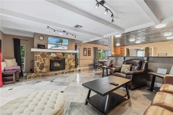 Living room featuring a fireplace and beamed ceiling