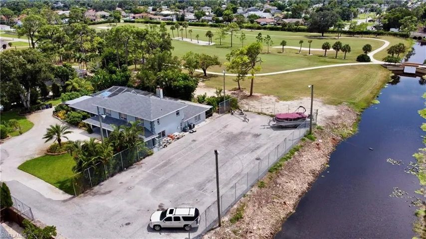 Birds eye view of property with a water view