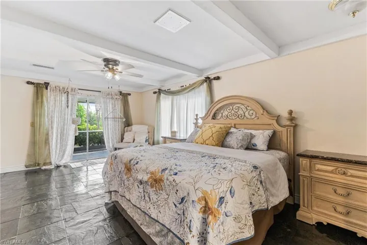 Bedroom with beamed ceiling, access to outside, and ceiling fan